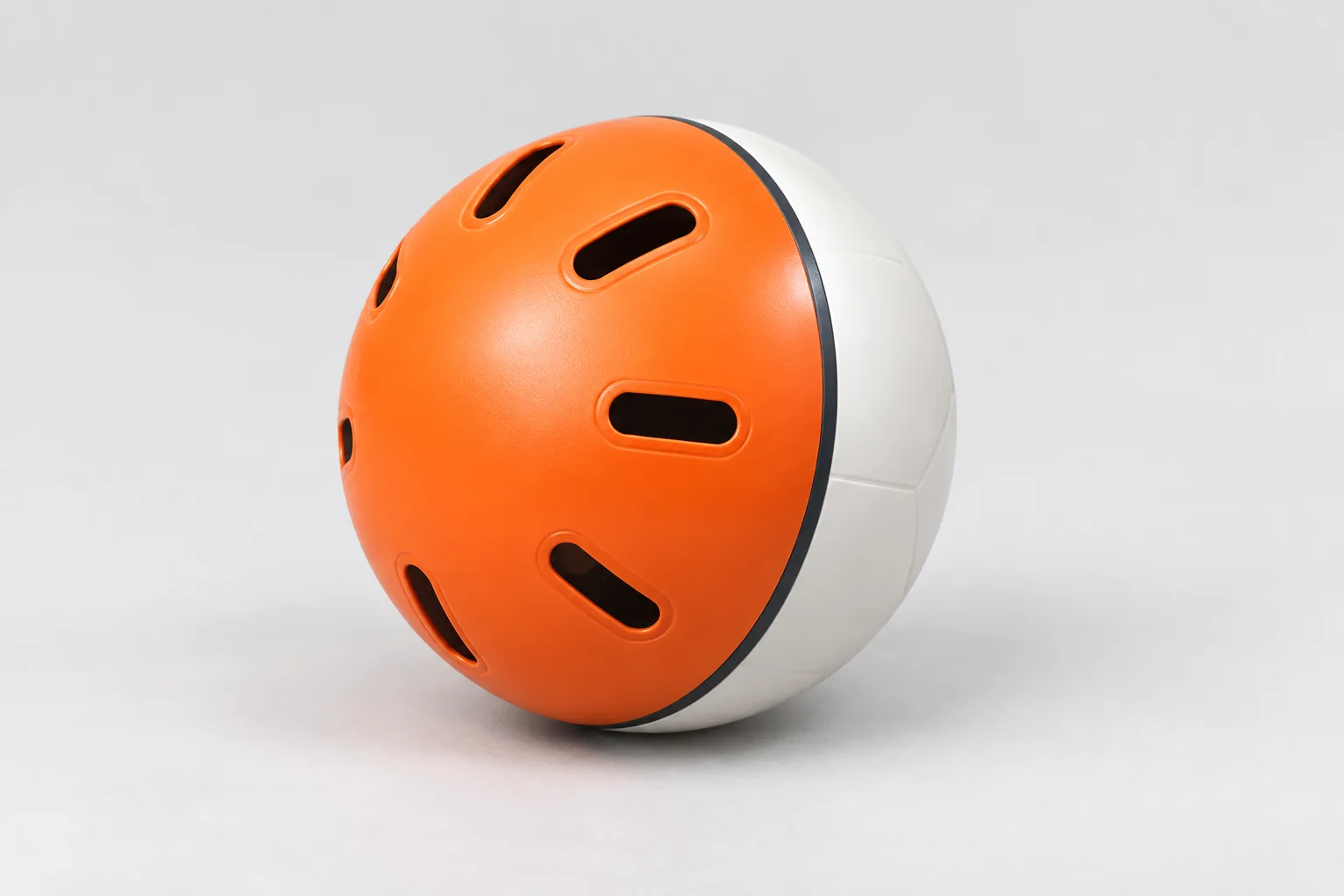 Concept image of the ball: bright orange slotted half and white solid half